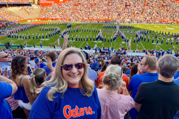 Woman at a football game enjoying a beautiful day